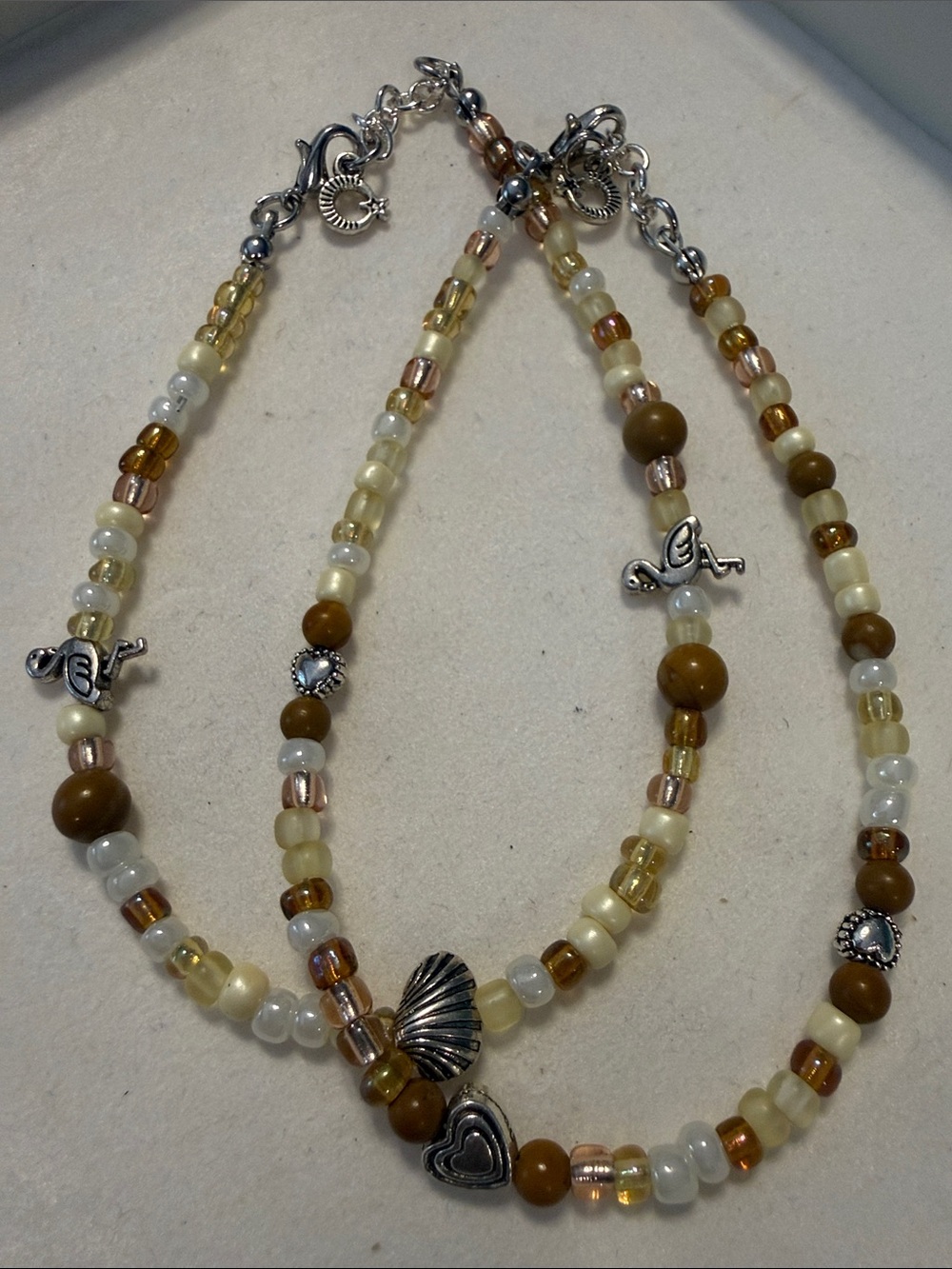 Handcrafted Brown,cream and white. Beaded anklet bundle with Silver Accents